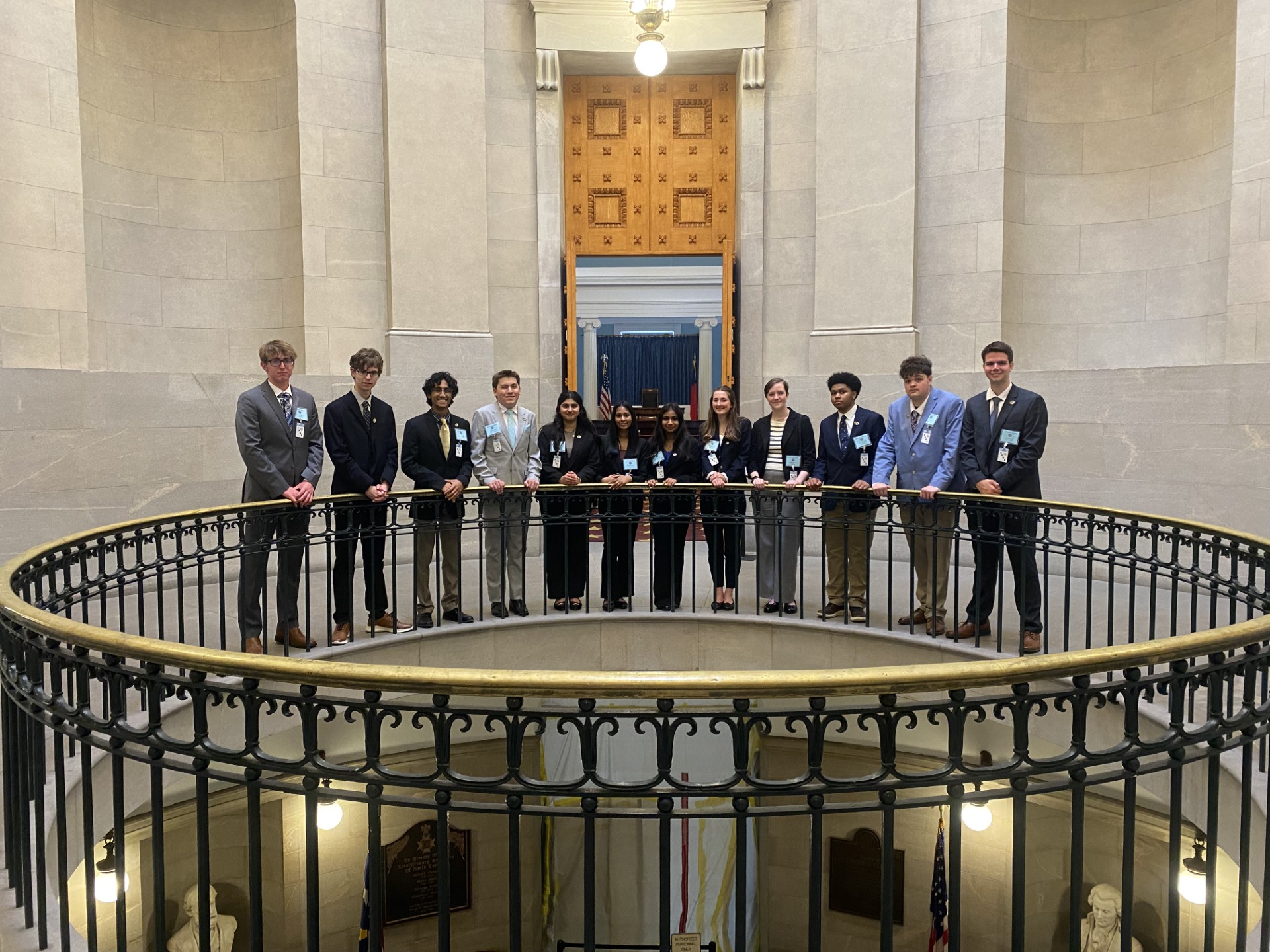 11 Senate Pages pose inside the Capitol building.